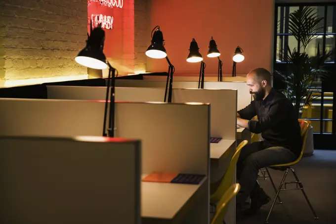 man working late in co-working space