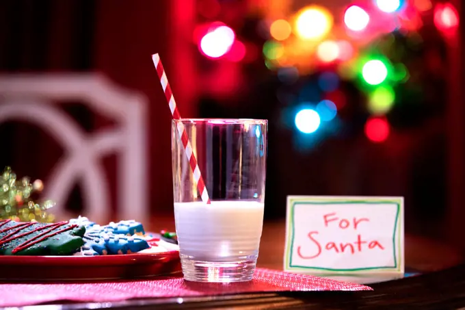 Milk and cookies sitting out on a table overnight left for Santa Claus. 