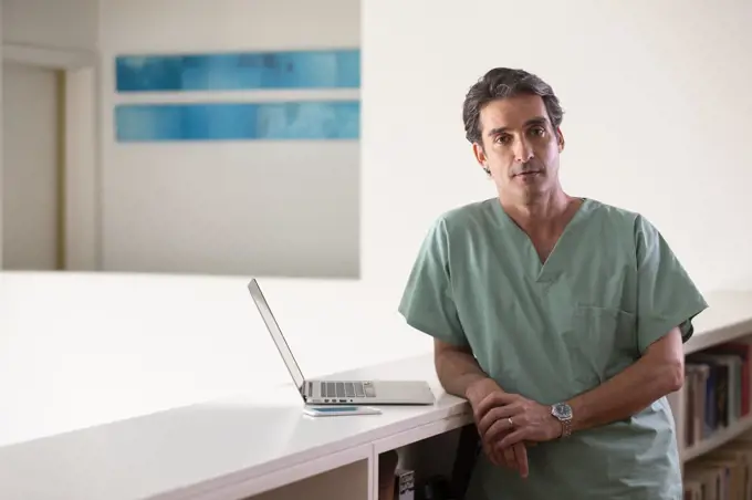 Portrait of Hispanic Male doctor in his home taking a break from practicing Tele-medicine