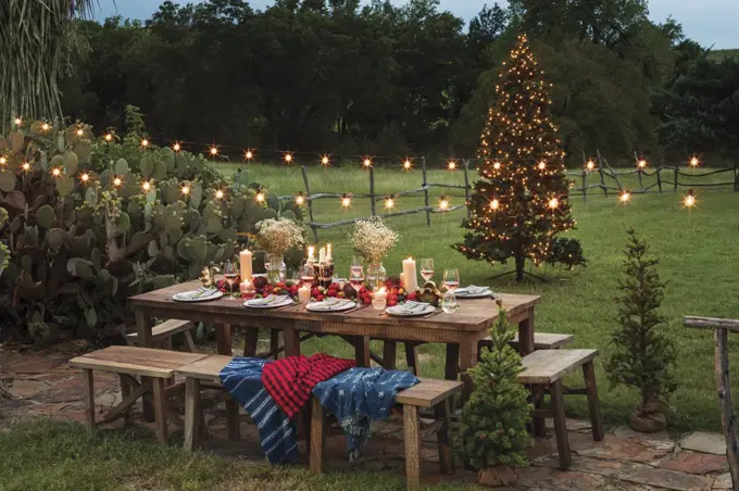 Outdoor dining table with elegant and festive table setting for the holidays 