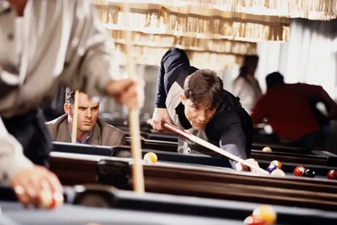 Men playing pool in a billiards bar