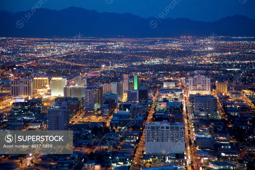 Downtown Las Vegas Skyline at Night with city lights and mountains
