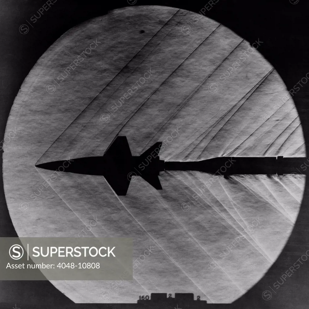 Supersonic Shocks waves attached to a small scale model of the X-15 experiment rocket plane. Mar. 23, 1962.