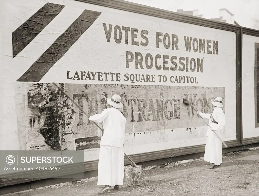Women suffragists cover a billboard to advertise their Washington, D.C. parade. Nation-wide demonstrations were held in May 1914 to support the Federal Amendment enfranchising women.
