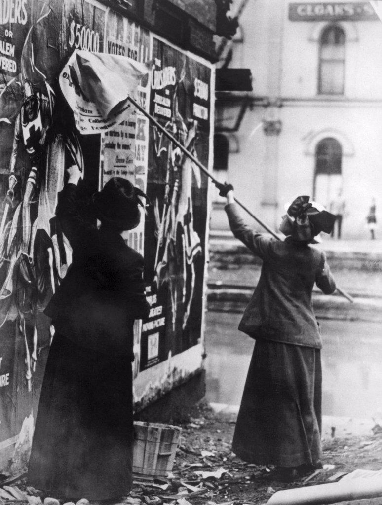 Two suffragettes posting a billboard in New York City, c. 1917.