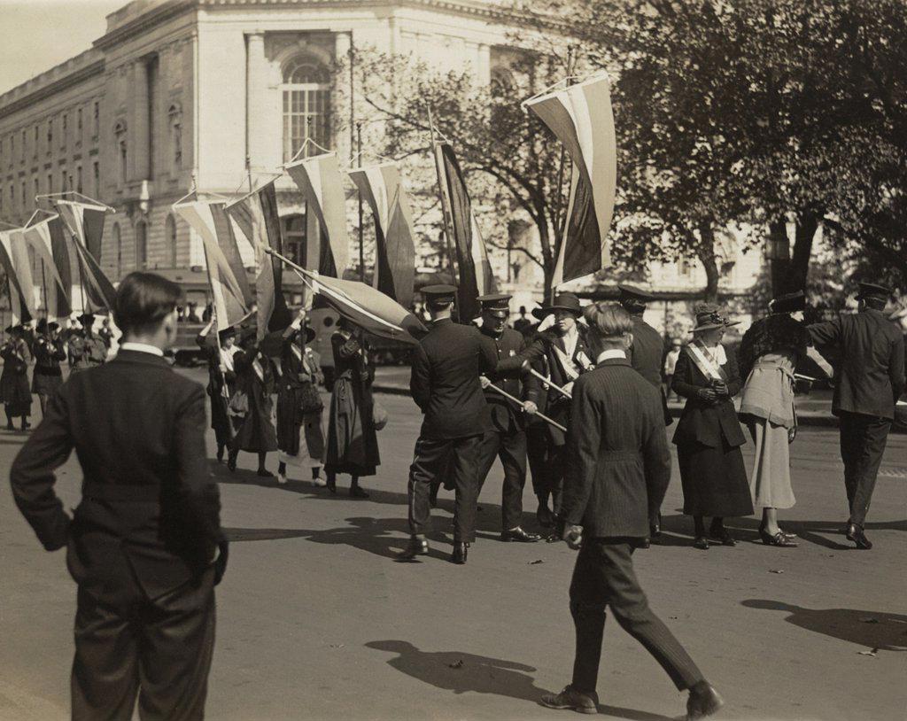 Police confront a line of National Woman's Party pickets and seize their banners on Constitution Avenue, outside Senate Office Building in October 1918.