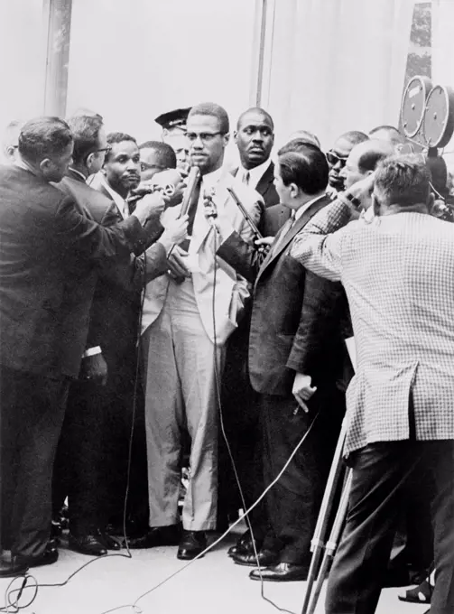 Malcolm X being interviewed by reporters in New York, 1964.