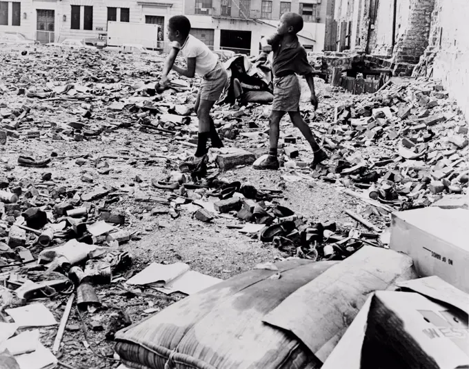 African American boys playing in vacant lot. They make a debris strewn lot their playgound on Manhattan's West 91st Street. 1962.