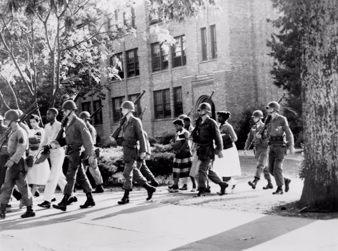 African-American students leaving Central High School under military escort, Little Rock, Arkansas. Sept.- Oct. 1957.