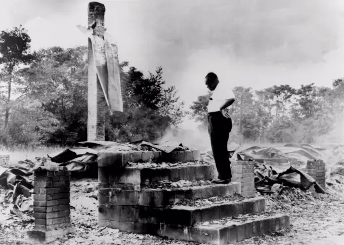 Pastor H.C. McClain looking over the burned ruins of his High Hope Baptist Church, Dawson, Georgia. It was the fourth in a series of African American church burnings, presumably to discourage Civil Rights activism. September 17, 1962