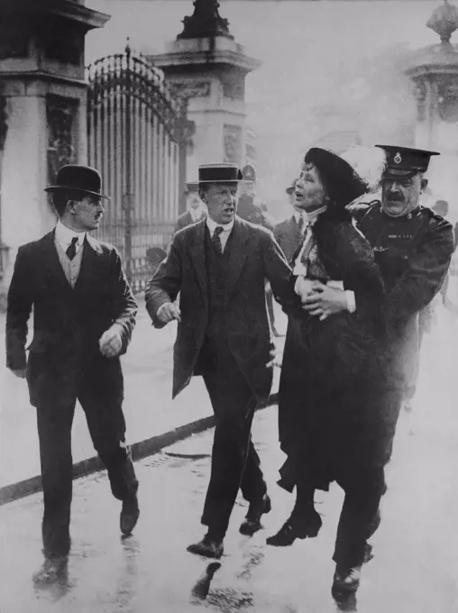 British suffragette Emmeline Pankhurst arrested and carried away by a policeman for leading suffragettes attempt to present a petition to King George V at Buckingham Palace. June 2, 1914.