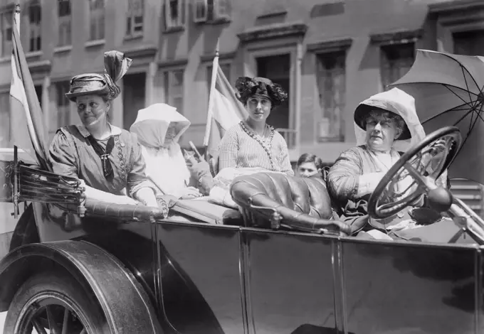 Women's suffrage leaders in an open car at a Votes for Women parade in New York City. Photo shows Susan Walker Fitzgerald, Emma Bugbee, Maggie Murphy, and Harriot Stanton Blatch. Blatch was the daughter of 19th century women's rights leader Elizabeth Cady Stanton. July 30, 1913.