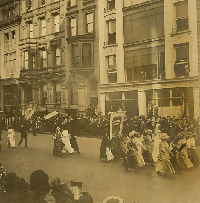 New York City suffrage parade, with crowds along street. Anne Fitzhugh Miller, a prominent reformer, is in the middle group of three women. May 6, 1911.