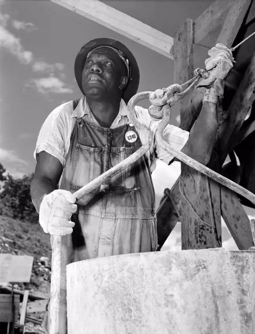 African American construction worker at the Douglas Dam on the French Broad River, one of the Tennessee Valley Authority public works projects of the New Deal. June 1942.