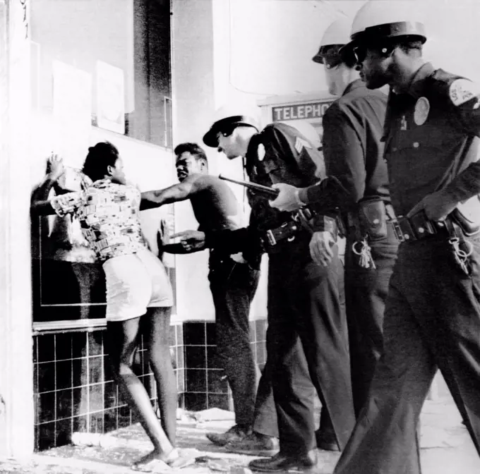 Fifth Day of the 1965 Watts Riots. Police search two African Americans suspected of looting a market. August 15, 1965.
