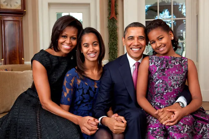 President Barack Obama, First Lady Michelle Obama, and their daughters, Malia, left, and Sasha, right, sit for a family portrait in the Oval Office, Dec. 11, 2011.