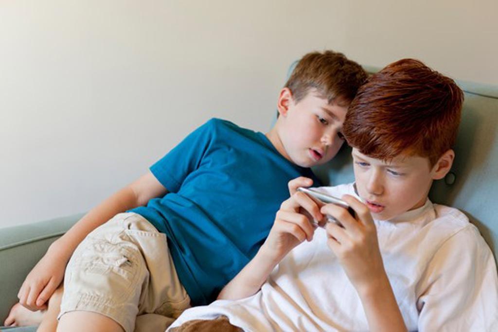 Boys playing on cell phone