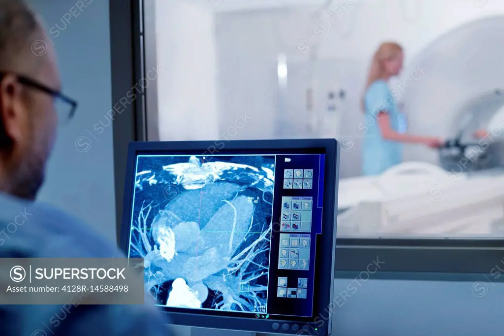Doctor looking at MRI scan on monitor