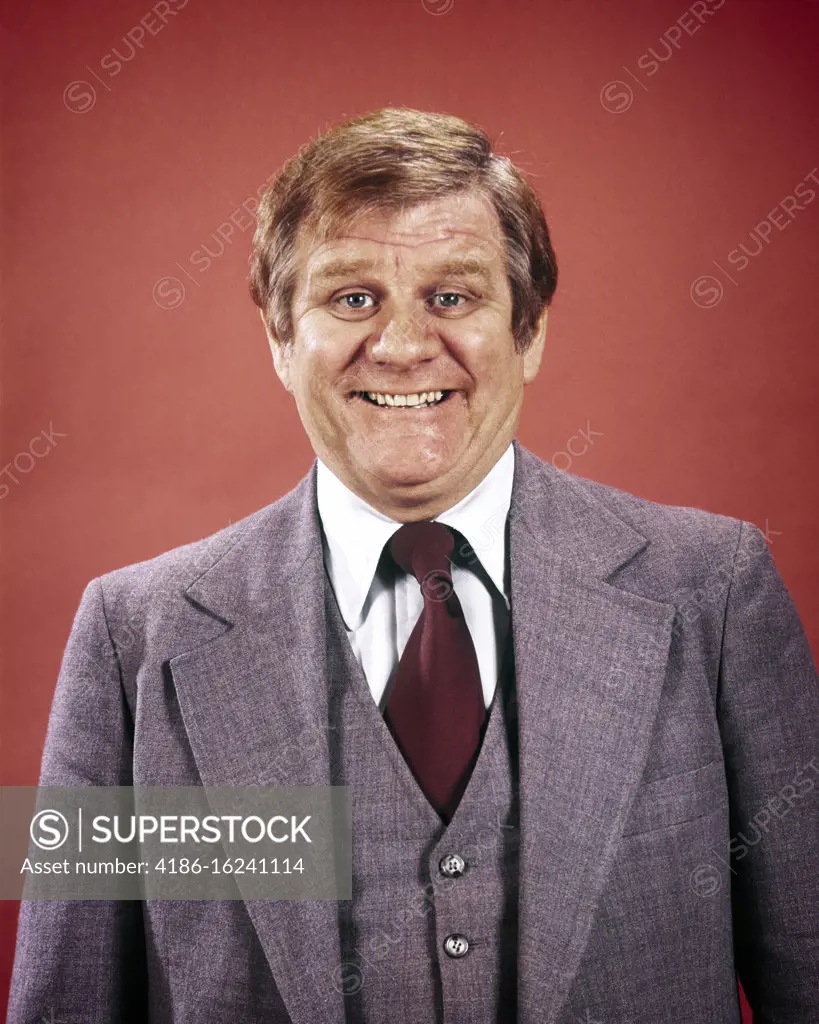 1970s 1980s PORTRAIT GRIMACING PORTLY BUSINESSMAN WEARING THREE PIECE SUIT LOOKING AT CAMERA