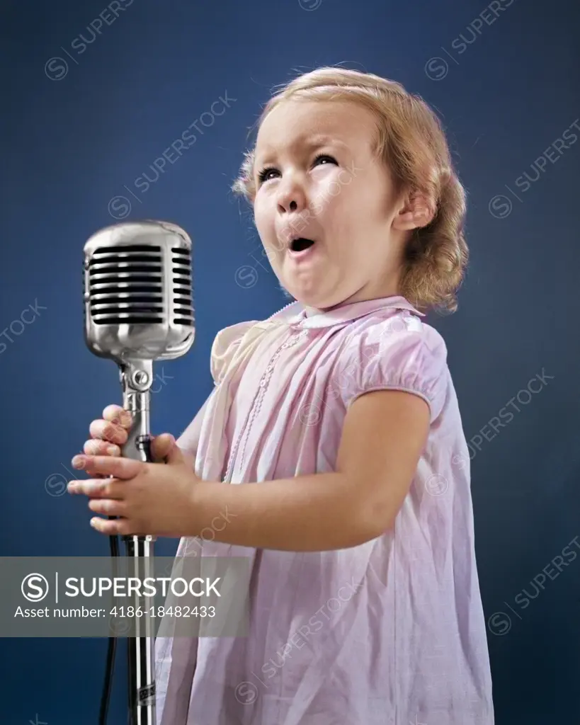 1940s LITTLE GIRL MAKING FACE SINGING INTO MICROPHONE