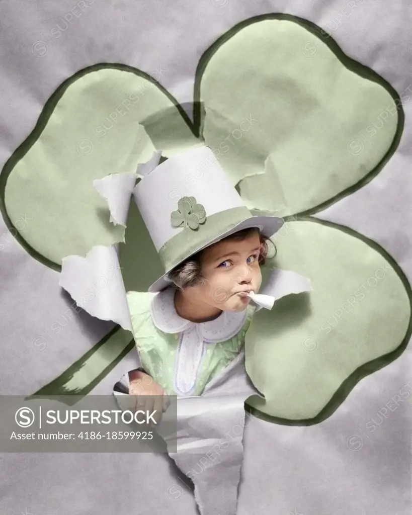 1930s CHARMING SMILING IRISH GIRL IN TOP HAT WITH SHAMROCKS BLOWING ON CLAY PIPE BURSTING THROUGH A SHAMROCK LOOKING AT CAMERA