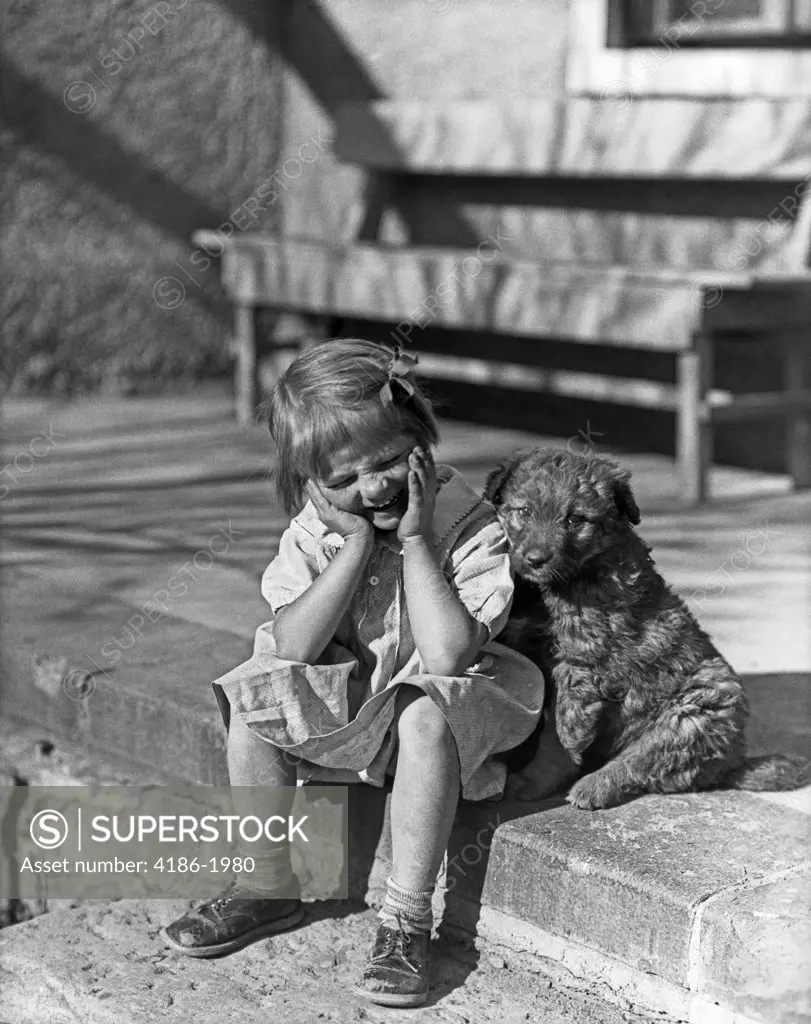 1930S Little Girl Sitting On Porch Stoop Funny Expression Hands Up To Her Face Beside Her Dog
