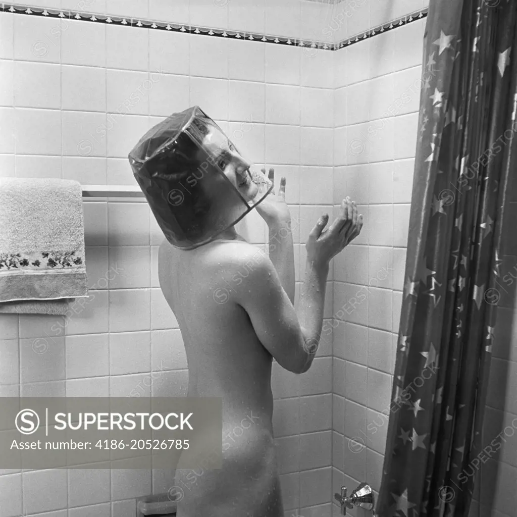 1930s NUDE WOMAN IN SHOWER WEARING CLEAR PLASTIC SHOWER CAP WHICH COVERS HER ENTIRE HEAD