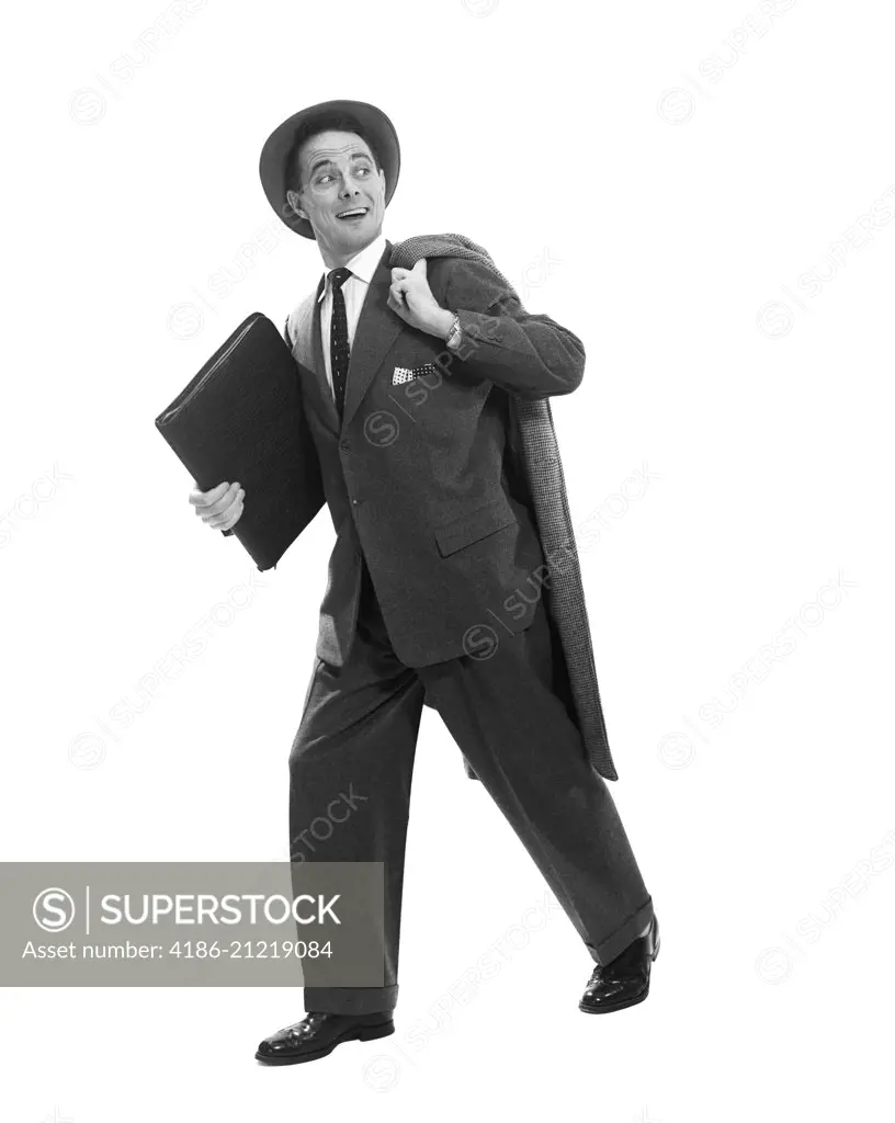 1950s SALESMAN BUSINESSMAN BRIEFCASE HAT WALKING COAT OVER SHOULDER SMILING EXPRESSION LOOKING BACK OVER SHOULDER AT COMPETITION