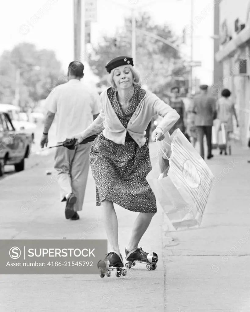 1960s 1970s WOMAN CHARACTER A SHOPPING BAG LADY WITH FUNNY FACIAL EXPRESSION WEARING ROLLER SKATES SKATING ON CITY SIDEWALK
