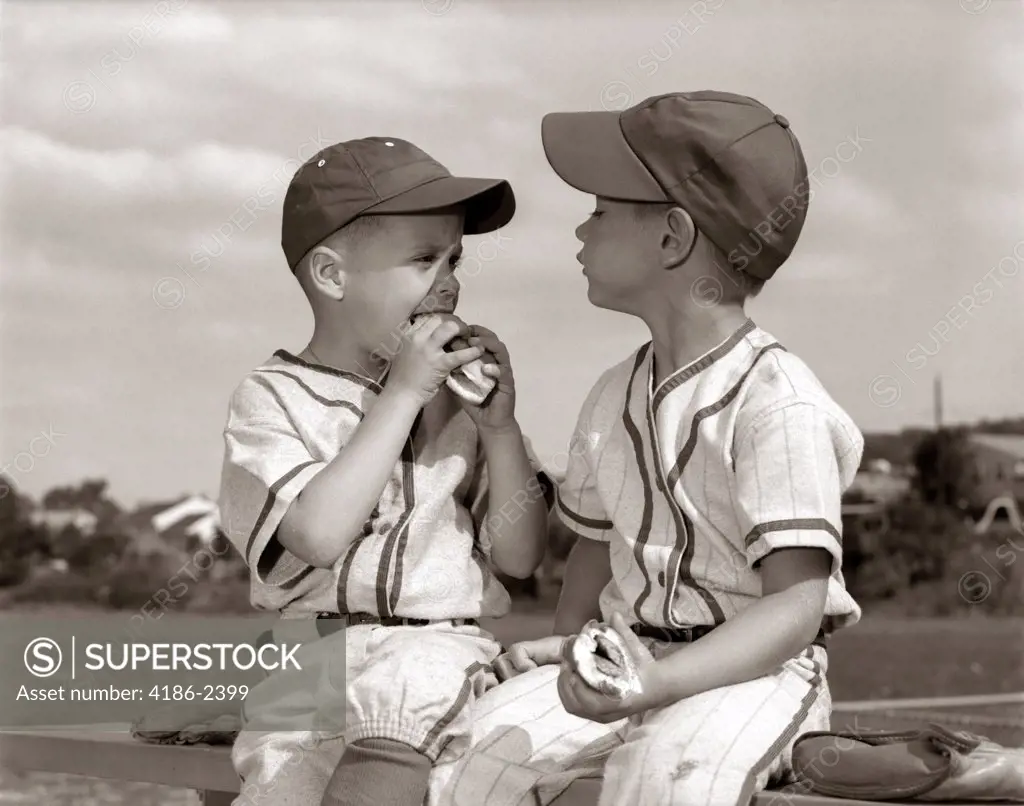1960S Youth League Boys In Caps And Uniforms Eating Hot Dogs