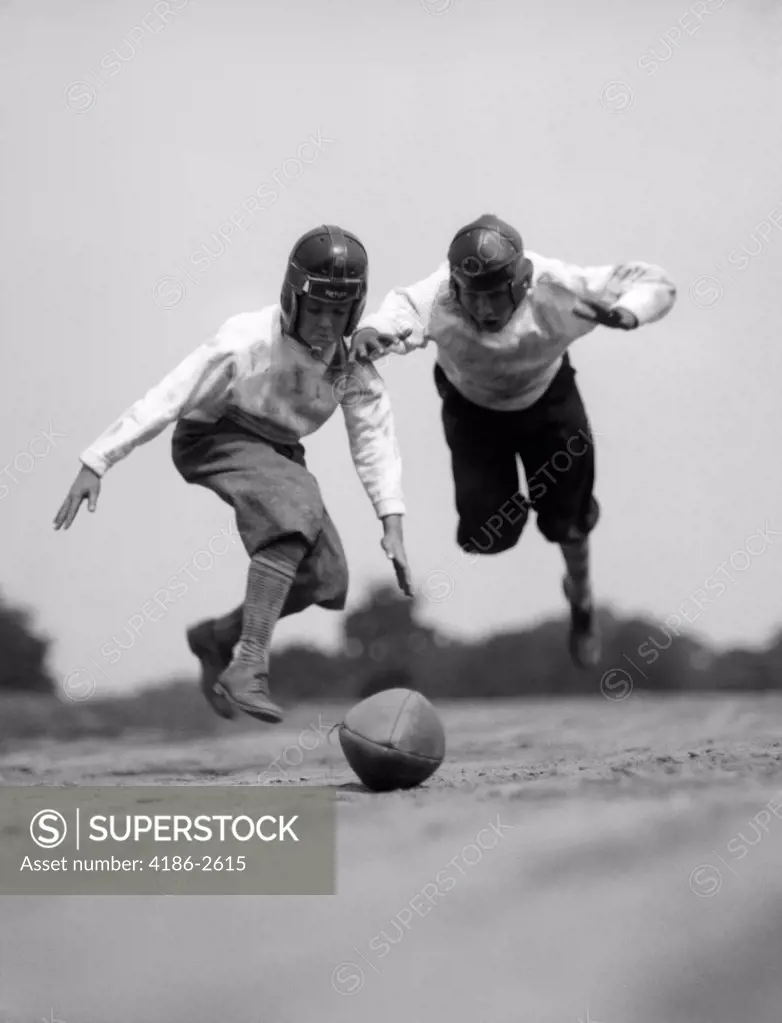 1930S Pair Of Boys In Knickers & Helmets Racing To Dive On Football