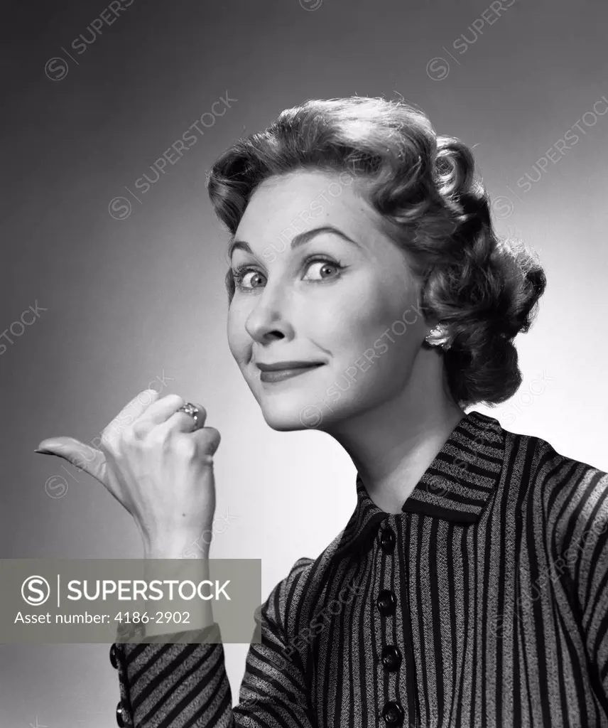 1960S Portrait Of Proud Smiling Woman Making Go Away Gesture With Thumb Studio