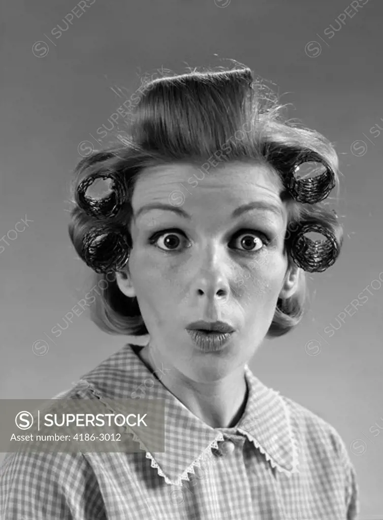 1960S Portrait Woman With Hair In Rollers Eyes Wide With Surprise