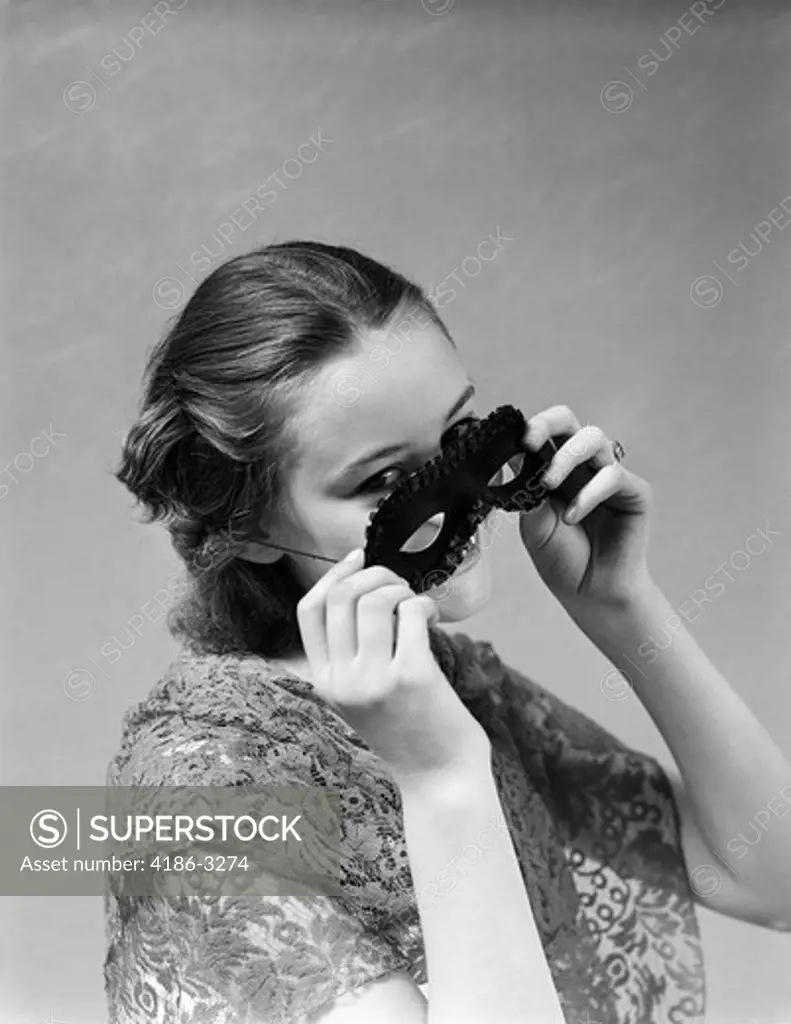 1930S 1940S Woman Putting On Taking Off Black Eye Mask