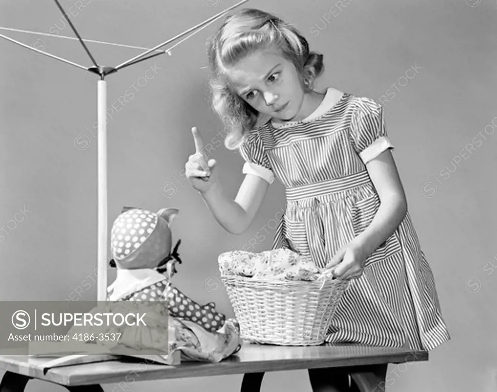 1940S Girl Shaking Her Finger At Doll Over Toy Laundry Basket