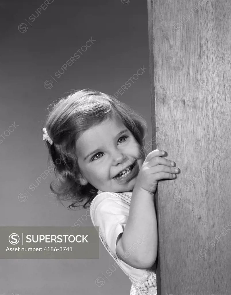 1960S Child Little Girl Smiling Peeking Around Corner