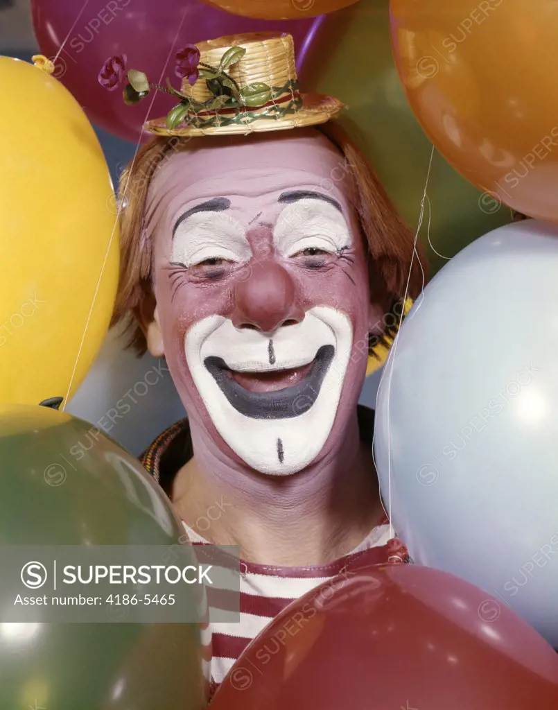 1960S Close-Up Portrait Of Clown Surrounded By Balloons Face Make-Up Design Fairs Smiling Funny