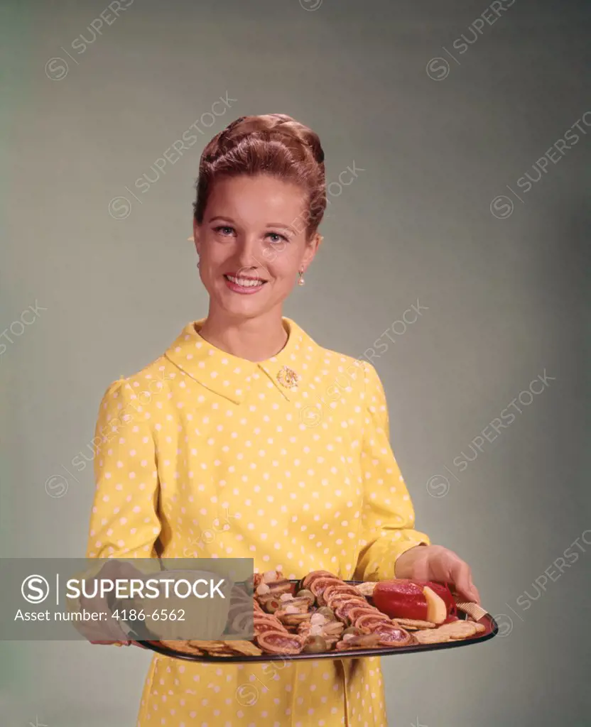 1960S Woman Holding A Tray Of Party Snack Food Smiling Studio Indoor