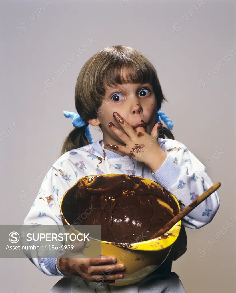 1980S 1990S Little Girl Eating Chocolate Icing From Bowl 