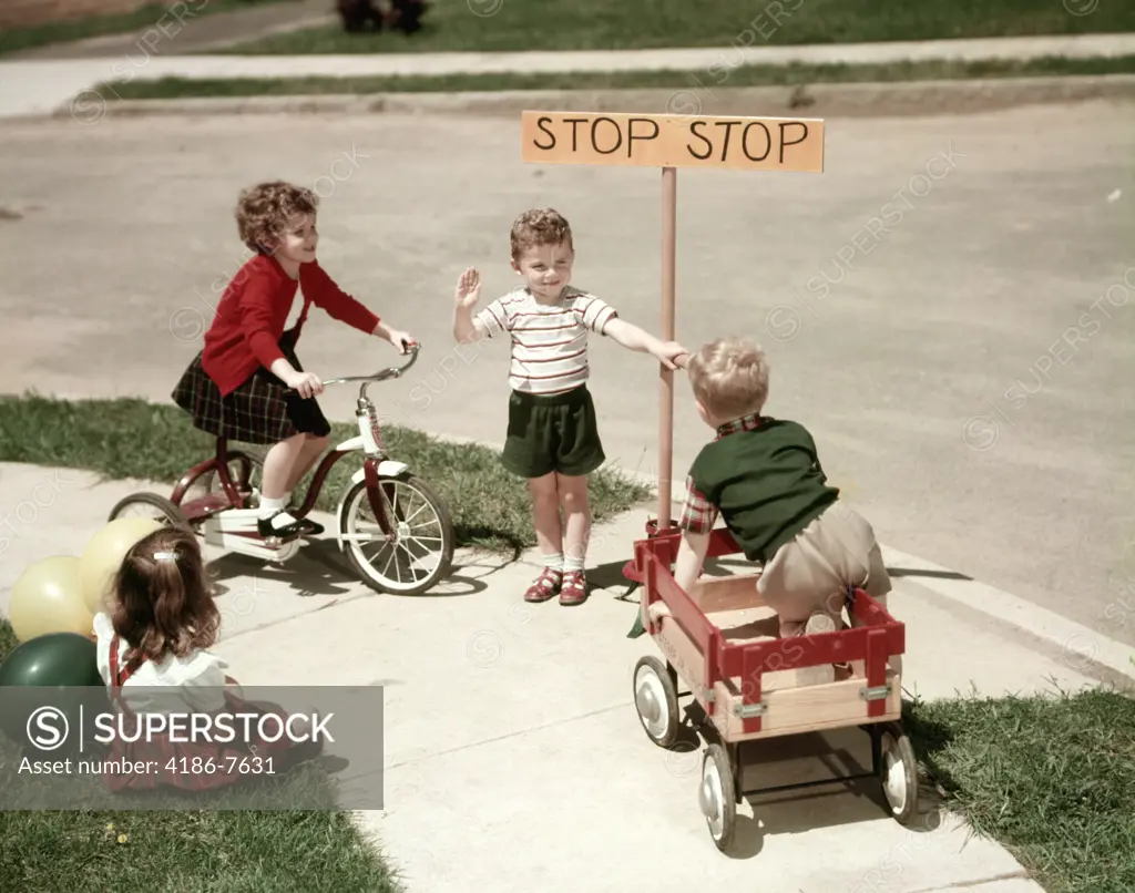 1950S Boys And Girls Outdoor With Tricycle And Wagon Playing Traffic With Police Stop Sign Americana