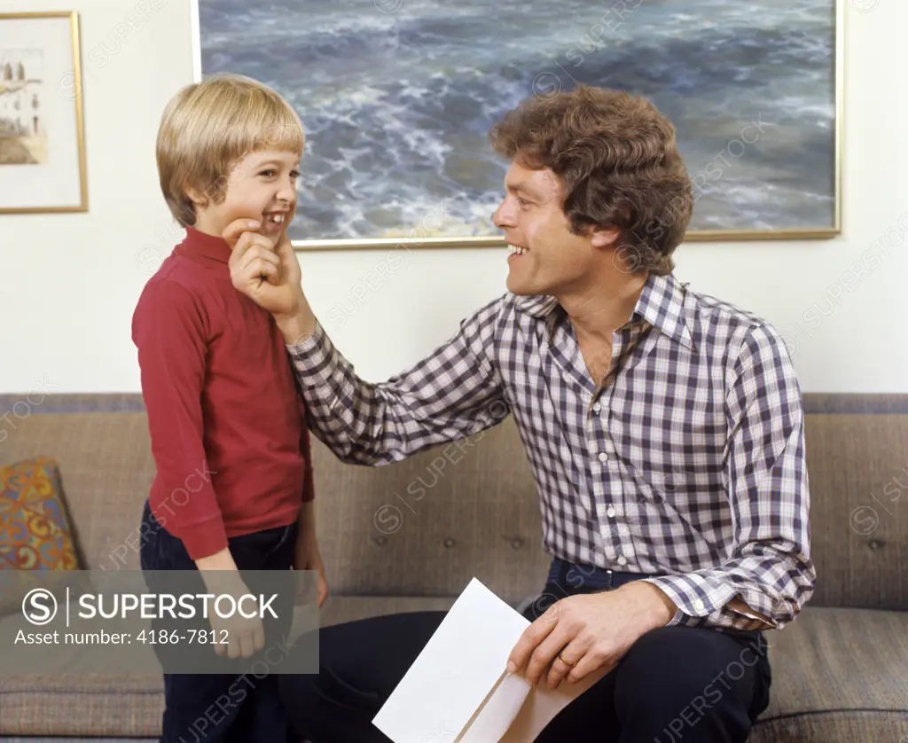 1970S Father And Son Laughing Talking Touching Couch Man Boy