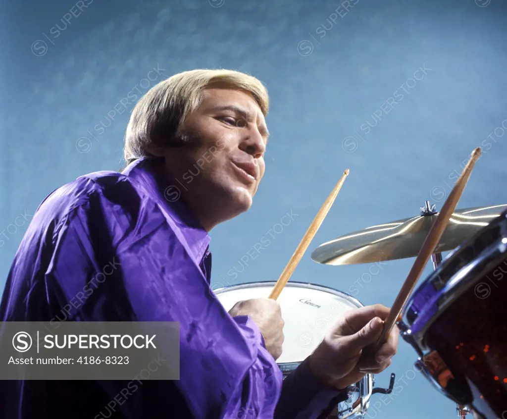 1970S Musician Blond Man Playing Drums Wearing Purple Shirt