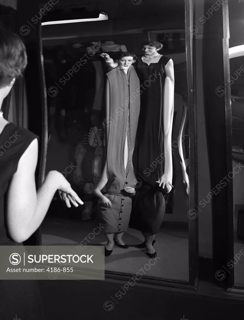 1950S Two Young Women Looking At Distorted Reflection In Fun House Mirror