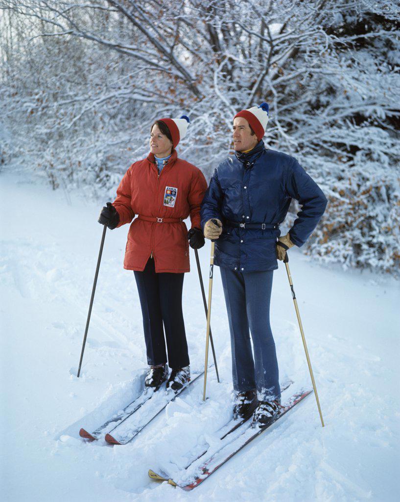 1970S Full Length Couple Standing On Skis Woman Red Jacket Man Blue Clothes