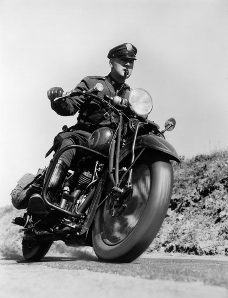 1930S Blurred Action Shot Of Motorcycle Policeman Driving Fast Blowing Whistle Man Outdoor