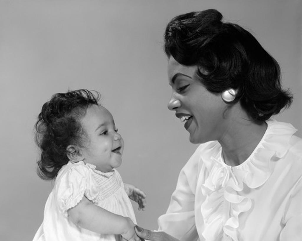 African-American Mother Smiling At Baby Studio