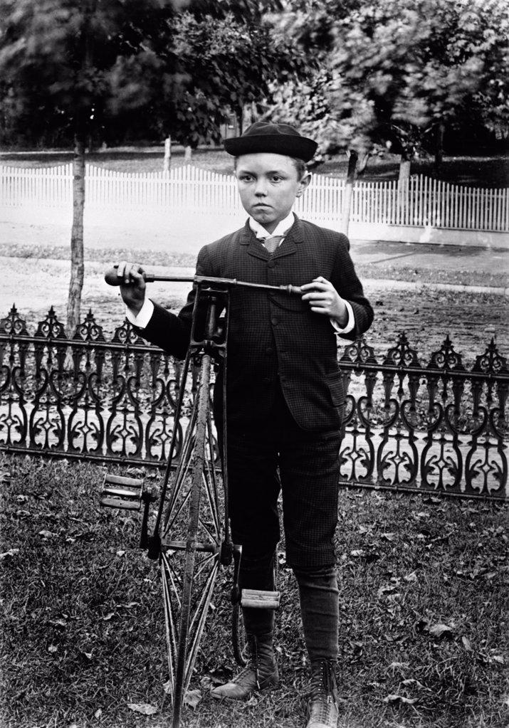 Turn Of The Century Boy Standing In Yard Next To Old Fashioned Bicycle
