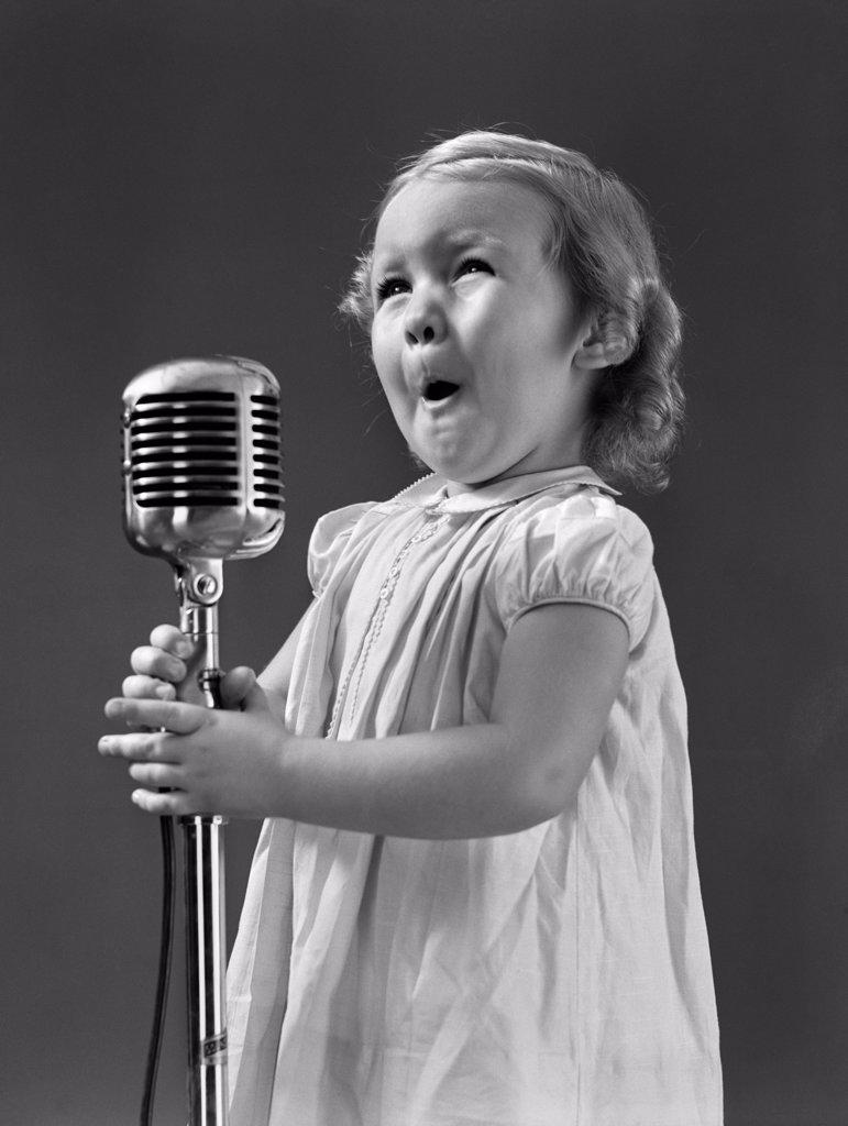 1940S Little Girl Making Face Singing Into Microphone