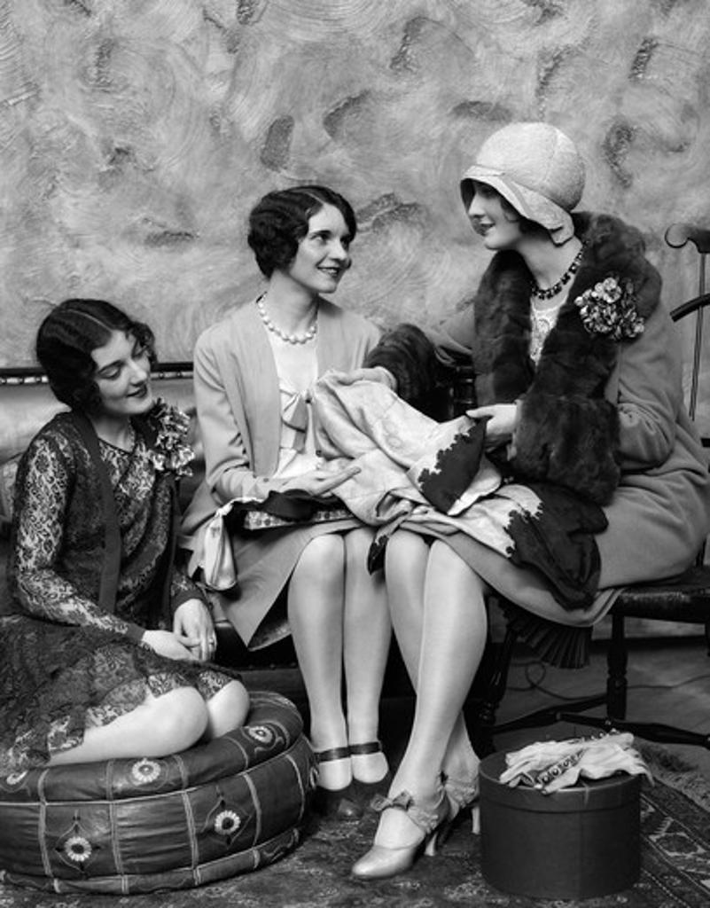 1920S Woman In Coat & Hat Back From Shopping Showing New Purchases To Two Friends