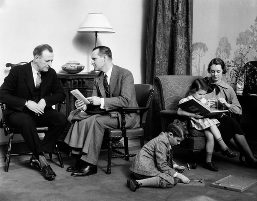 1930S Family In Living Room Father Talks To Salesman Insurance Mother Knits In Chair With Daughter